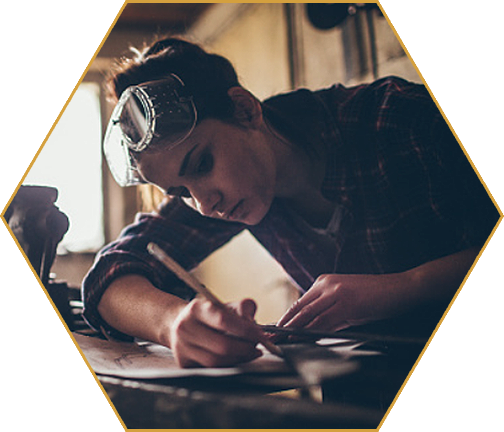 woman with goggles drawing a plan